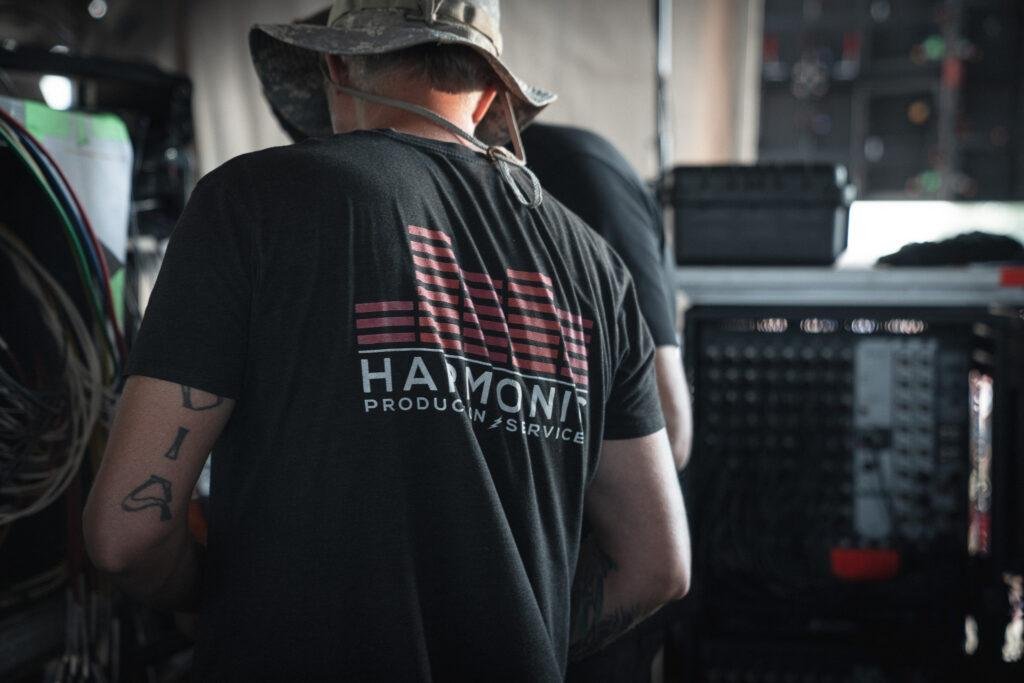 Harmonic Production event management services team setting up backline equipment for an event