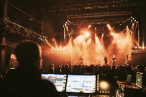 sound engineer behind consoles at live concert